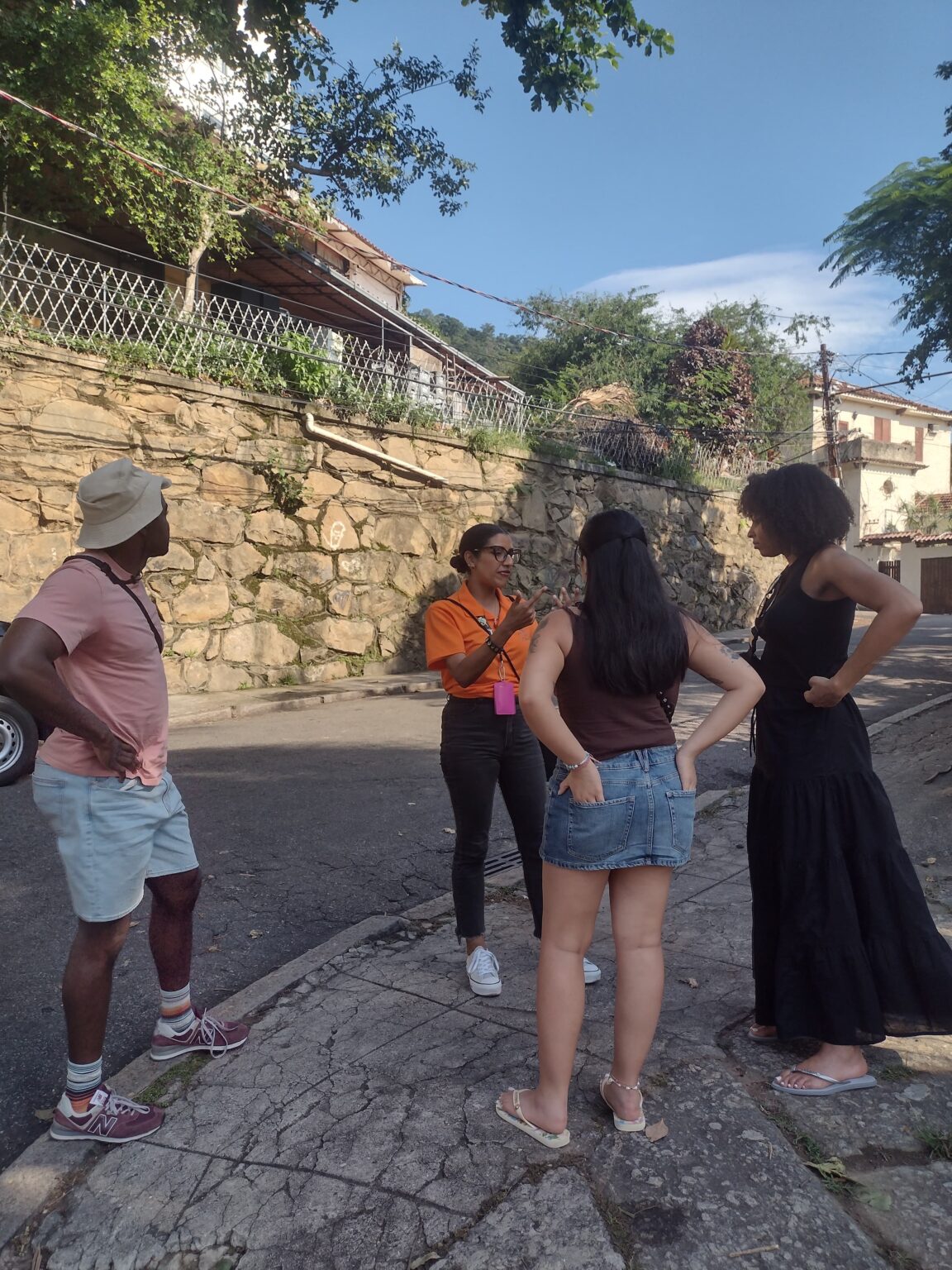 Travelers walking along a cobblestone street in Santa Teresa, Rio de Janeiro