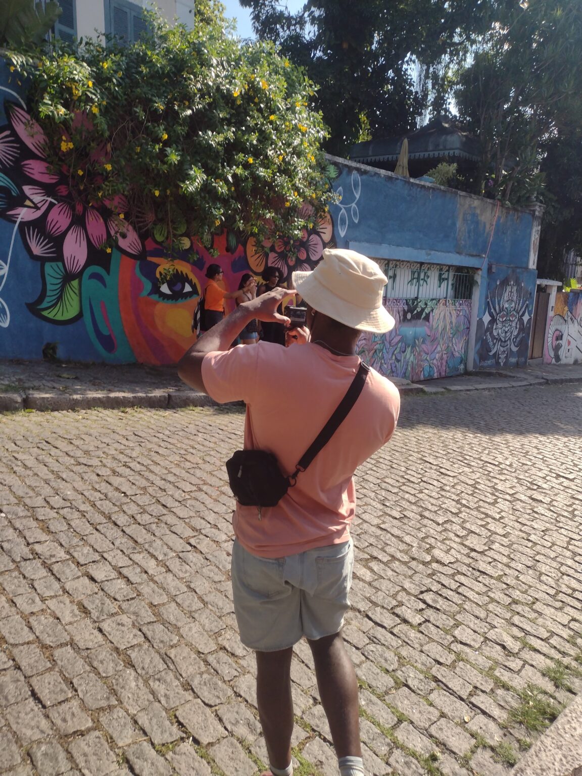 Traveler photographing street art in Santa Teresa, Rio de Janeiro