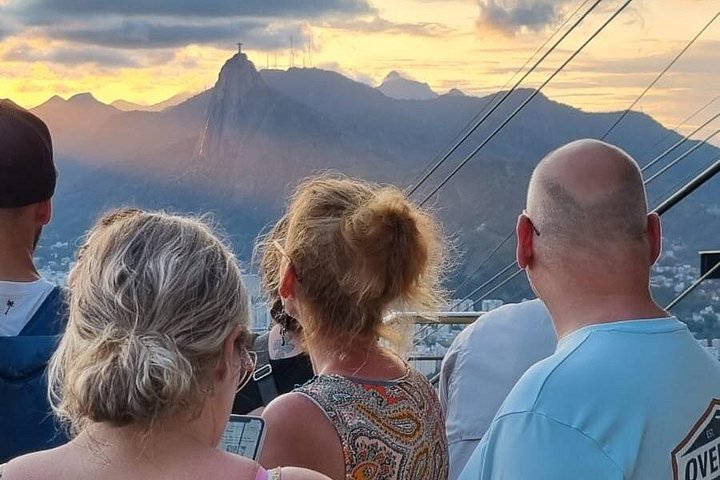 Travelers enjoying the sunset view from Sugarloaf Mountain