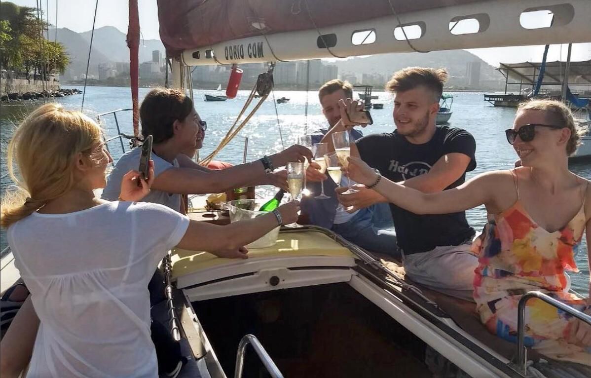 Friends making a toast on a private sailboat in Rio de Janeiro