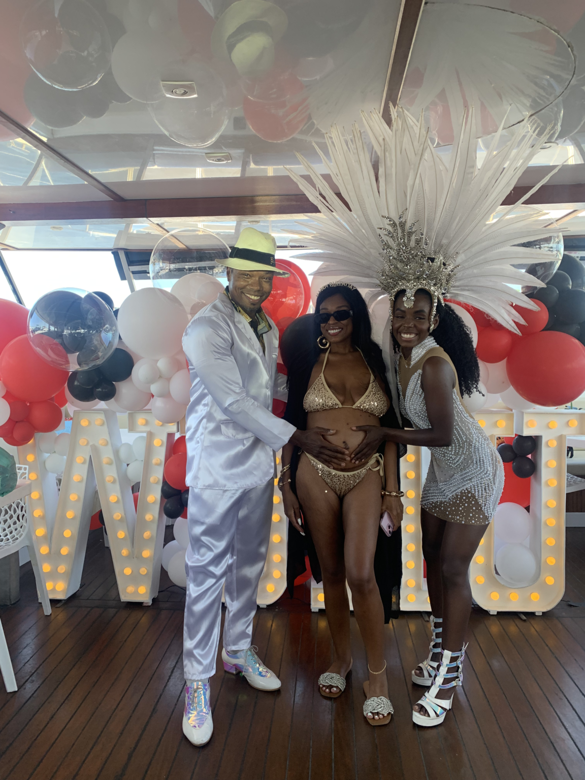 Samba dancers posing with guests at a private catamaran celebration in Rio