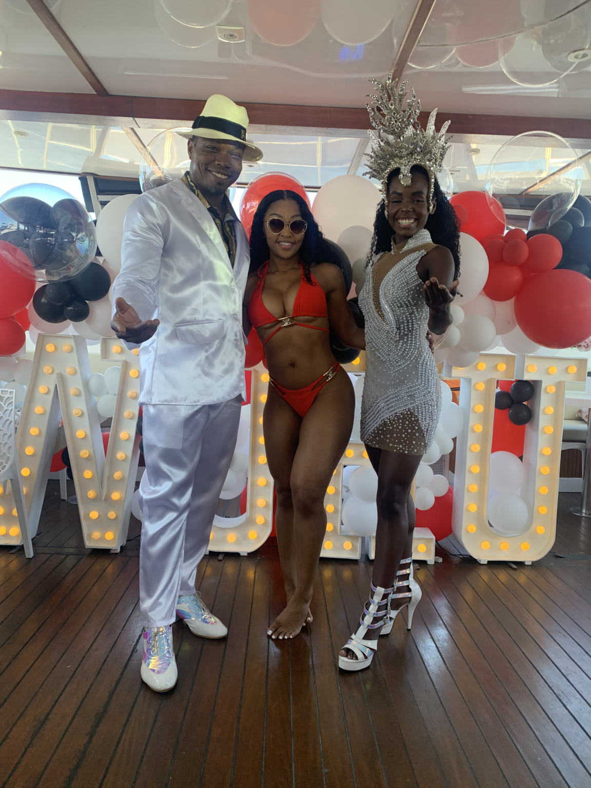 Samba dancers in Carnival costumes performing at a private catamaran party