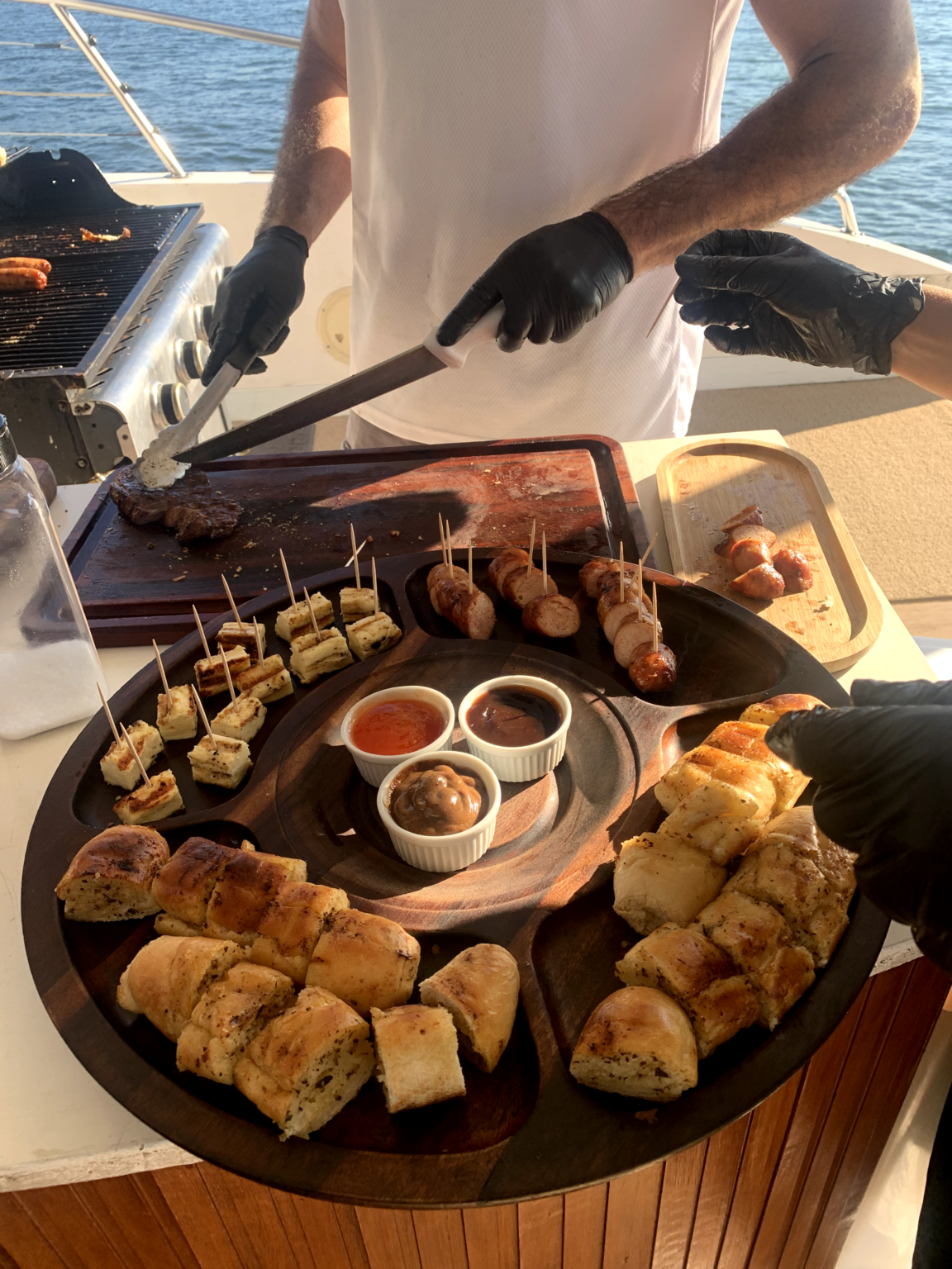 Chef serving Brazilian barbecue on board a private catamaran cruise